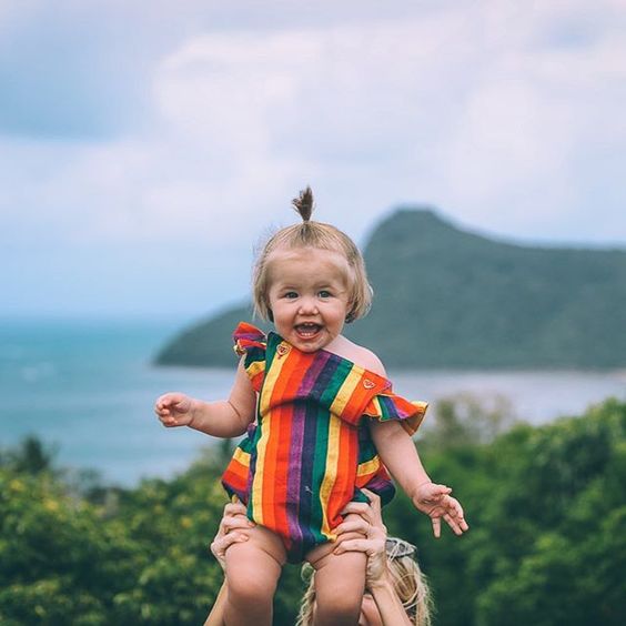 bold rainbow baby romper with ruffled cap sleeves
