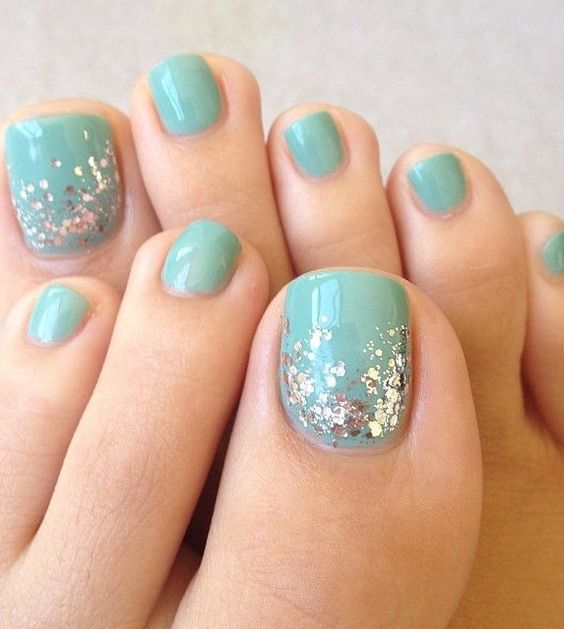 aqua-colored nails with silver sequins for a cool glam look