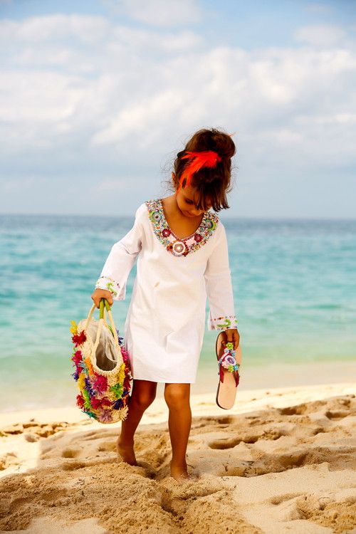 chic beach dress with long sleeves and embellishments as a beach cover up