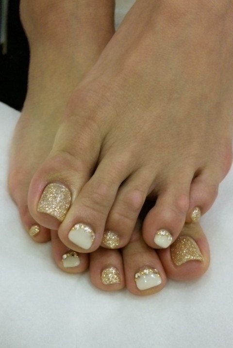 gold glitter nails and white ones with gold glitter touches