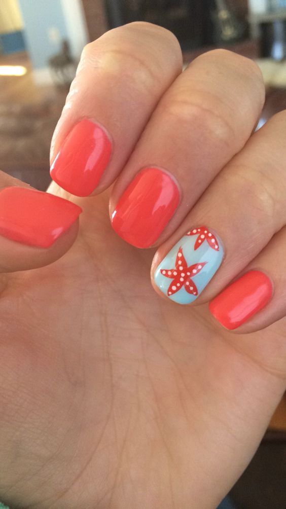red nails and an accent nail in powder blue with starfish decor