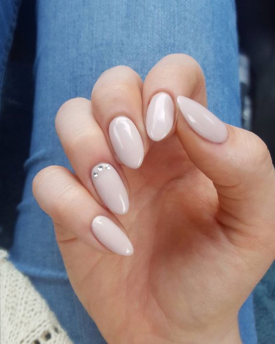 nude nails with an accent rhinestone one