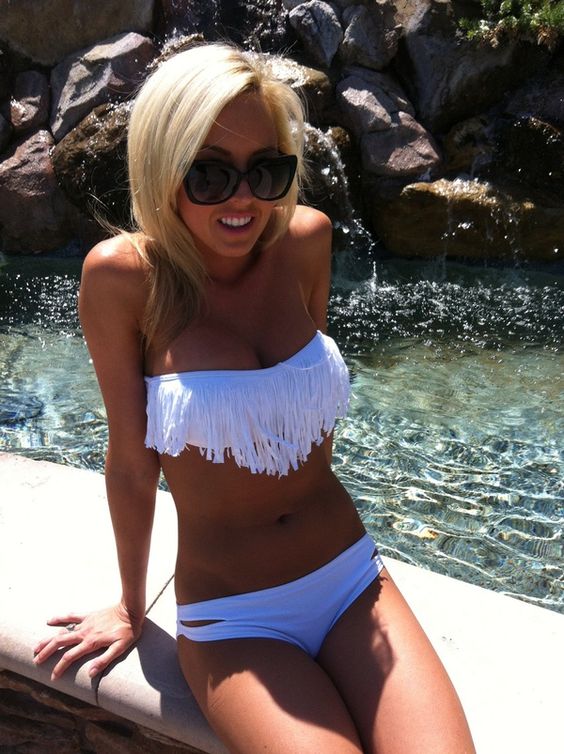 a white fringe top swimsuit with a cutout bottom