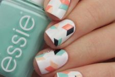 11 geometric nails in white, black, mint and orange with a chaotic geo design