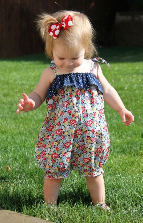 colorful floral print romper with a polka dot navy ruffle and straps