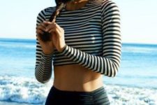 14 modest swimsuit with a high waist black bottom and a striped long sleeve top