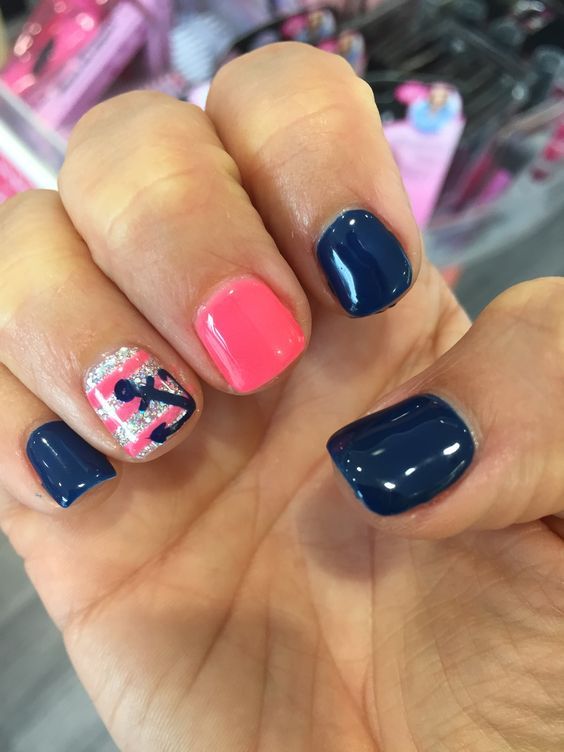 royal blue nails, a pink one and a striped glitter one with an anchor
