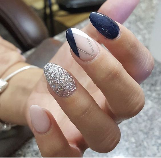 navy and blush nails with one silver glitter nail and one navy blush geo nail