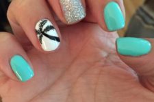 20 turquoise nails, silver glitter accent and a white nail with a black palm