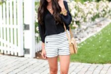 With black blouse, metallic sandals, beige bag and black and white hat