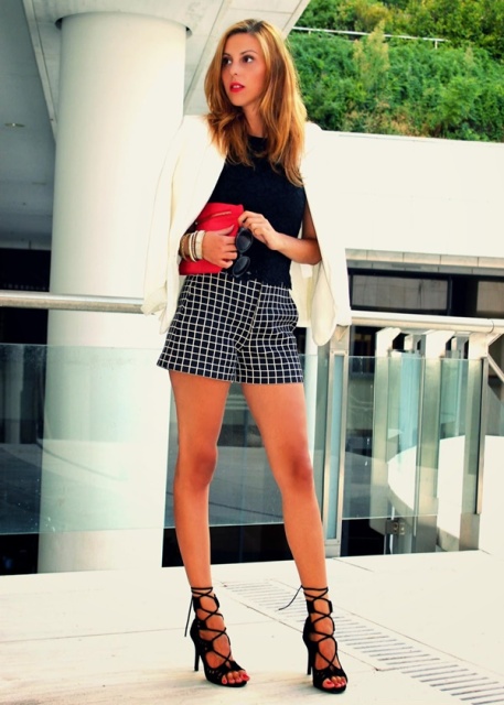 With black shirt, white blazer, red clutch and black lace up sandals