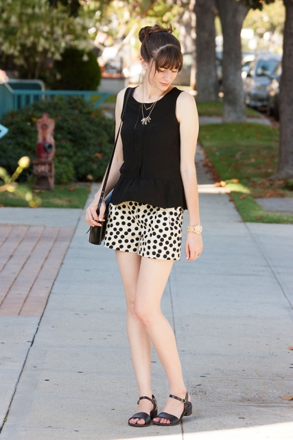 With black top, sandals and mini bag