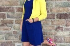 With blue dress and yellow jacket