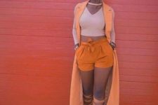 With crop top, orange long vest and lace up heels