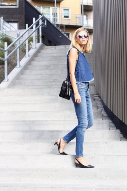 With denim top, jeans and black bag