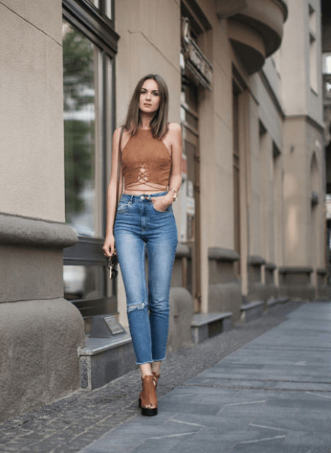 With distressed jeans and platform shoes