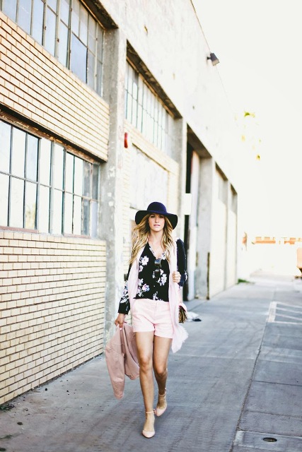 With floral shirt, black hat, pale pink scarf and flats