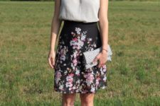 With floral skirt, printed clutch and black sandals