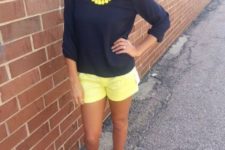With navy blue shirt, yellow necklace and sandals