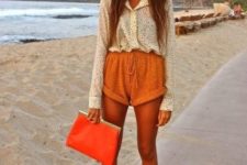 With printed shirt, white shoes, orange clutch and sunglasses