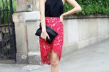 With red lace skirt, lace up shoes and black clutch