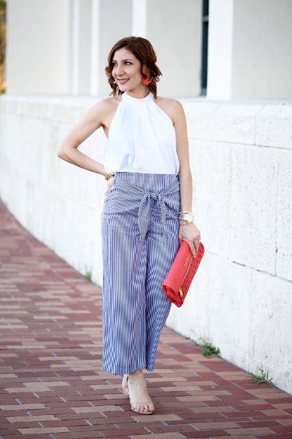 With striped pants, red clutch and sandals