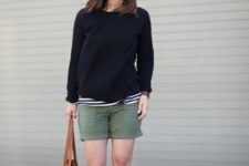 With striped shirt, black sweatshirt, beige sandals and brown tote