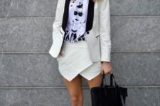 With t-shirt, black and white blazer, slip on shoes and black bag