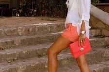 With white loose shirt, orange clutch and heels
