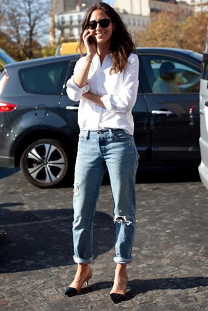 With white shirt and distressed jeans