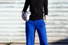 With white shirt, black sweatshirt, white clutch and pumps