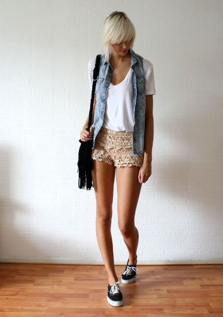 With white t-shirt, denim vest, sneakers and black bag