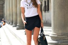 With white t-shirt, necklace, flats and big bag