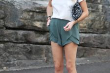 With white t-shirt, printed clutch and black cutout boots