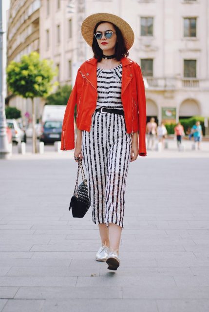 With wide brim hat, red jacket, white shoes and chain strap bag