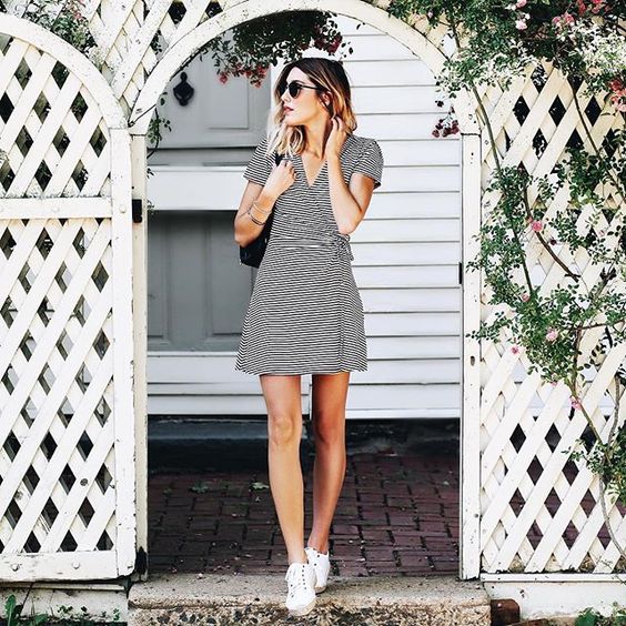 a black and white striped wrap mini dress with short sleeves and white sneakers for a comfy casual outfit