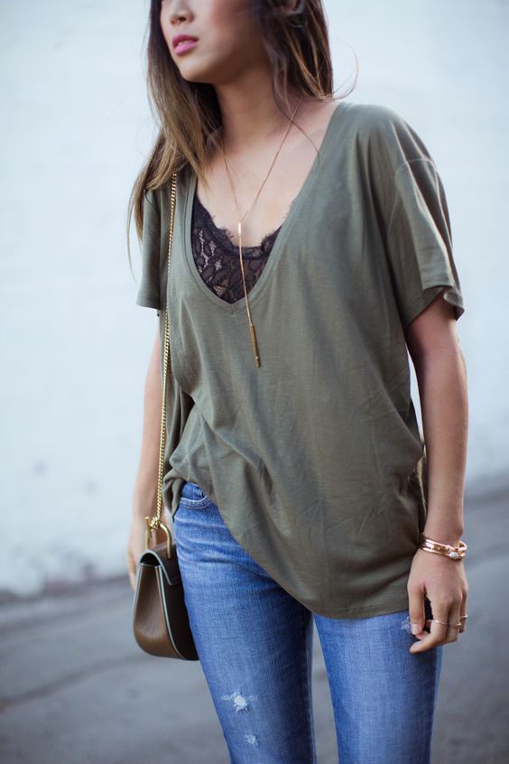 a black lace bralette with an oversized olive green tee and jeans for a sexy casual look