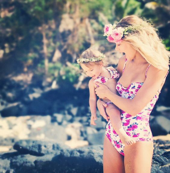 a pink floral one piece swimsuit for the mom and two piece for the daughter