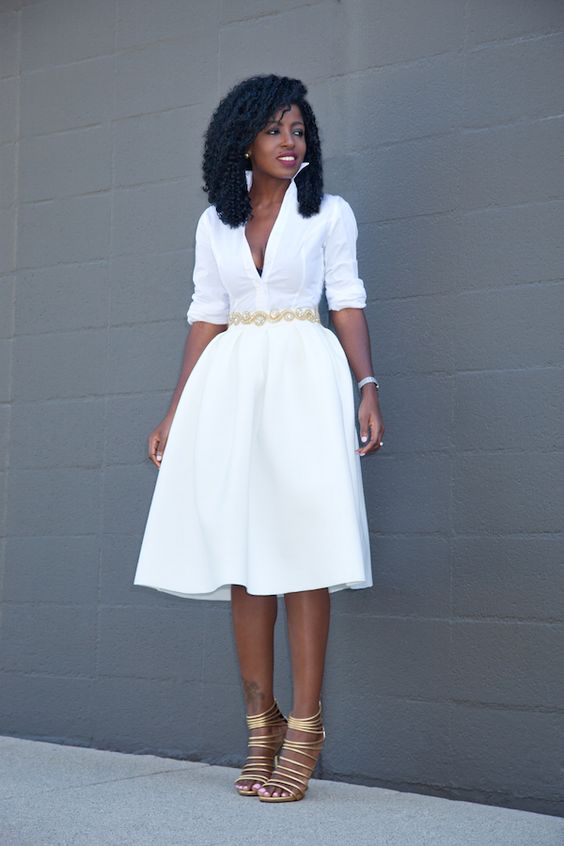 a white half sleeve dress with a deep V neckline, metallic shoes and accessories