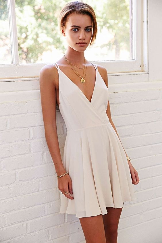 deep V-neck white mini dress with straps is a simple and elegant solution