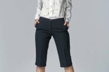 10 black bermuda shorts, a printed blouse and white pumps for a polished look