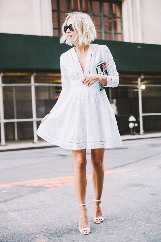 white perforated mini dress with a V-neckline and ankle strap heels