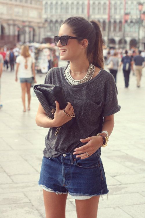 an oversized grey tee, denim shorts and lots of accessories create a chic look