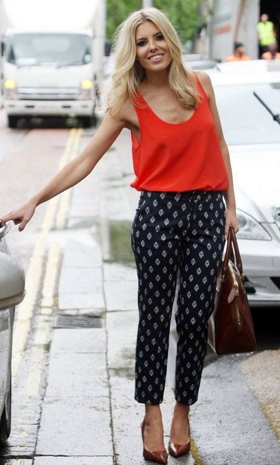 printed navy pants, a bold red strap top and brown shoes