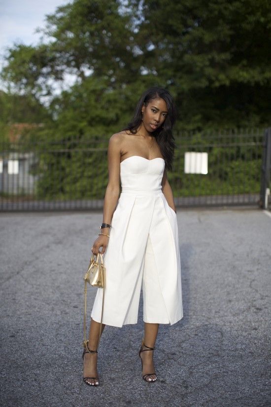 a strapless culotte jumpsuit, black ankle strap shoes and a metallic gold bag