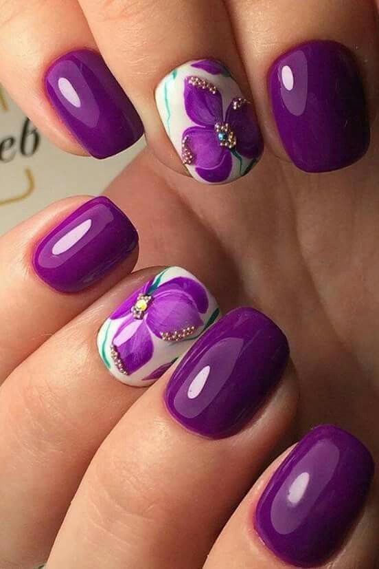purple manicture with accent floral nails with beads and rhinestones