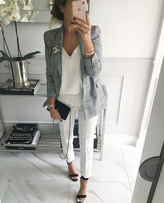 white trousers, a white V-neck top, ankle strap heeled sandals and a grey jacket