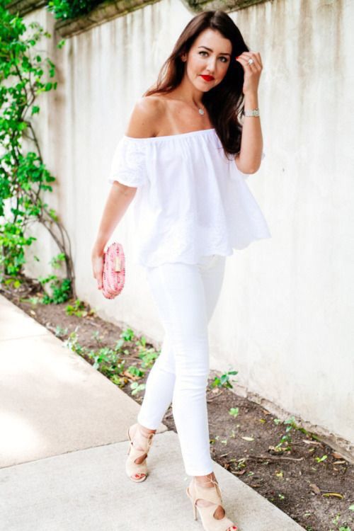white jeans, an off the shoulder top, a pink clutch and neutral cutout shoes