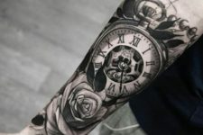Big rose and clock tattoo on the arm