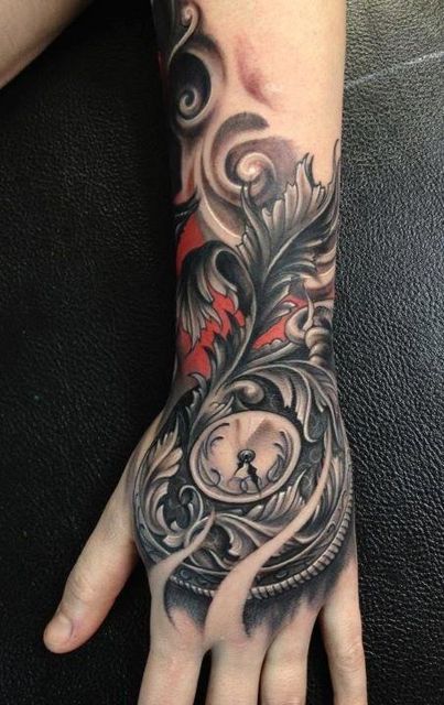 Black and red clock tattoo on the arm